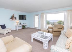a living room with a couch and chairs and a table at Sea Bluff #5 in Santa Rosa Beach