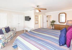 a bedroom with a bed and a couch at Sea Bluff #5 in Santa Rosa Beach +26 photos