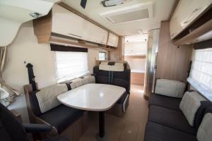an interior view of an rv with a table and chairs at Autocaravaning Menorca in Ferreries +1 photo