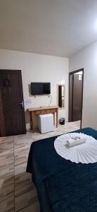 a room with a bed and a flat screen tv at Pousada Central Parque in Penha +35 photos