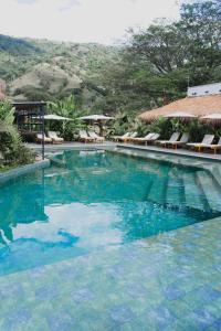 a large swimming pool with blue water at Anzalik Hotel Boutique in Anzá +55 photos