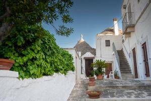 a street in a village with stairs and plants at Trullo Wanda in Alberobello