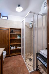 a shower with a glass door in a bathroom at Trullo Wanda in Alberobello +31 photos