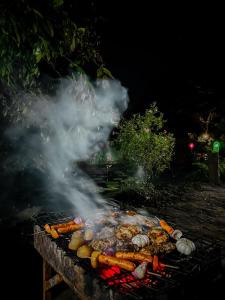 a grill with lots of meat and vegetables on it at Eco Lodge Meemure & Adventure Park in Meemure