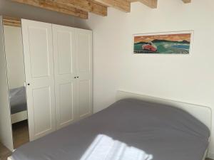 a bedroom with white cabinets and a bed at Villa Sur La Dune Moliets, 12 people, beach, golf in Moliets-et-Maa