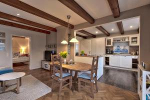 a kitchen and dining room with a wooden table and chairs at Ferienhaus Niels Hus Dagebüll in Dagebüll