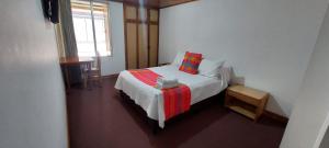 a small bedroom with a bed and a window at HOTEL SUAREL CENTER in Duitama