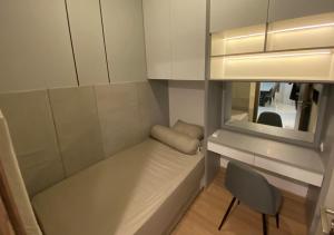 a small room with a bench and a chair at Sky House BSD in Samporo