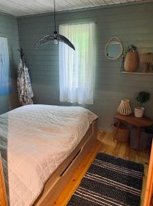a bedroom with a bed and a window at Cabin by Oppstrynsvatnet, Hjelle in Stryn