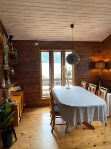 a dining room with a white table and chairs at Cabin by Oppstrynsvatnet, Hjelle in Stryn +24 photos
