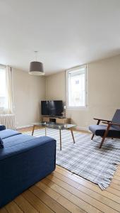 a living room with a couch and a table at Moulins F4 en centre ville Saint Dizier in Saint-Dizier +16 photos