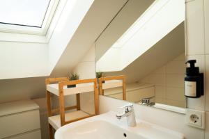 a bathroom with a sink and a skylight at homy Central City Oasis in Dornbirn in Dornbirn +31 photos
