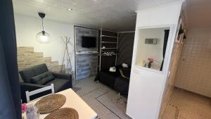 a small living room with a couch and a table at Zum Sterngässchen in Ludwigshafen am Rhein