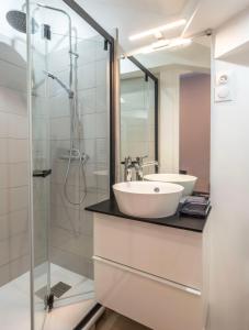 a bathroom with a sink and a shower at Studio centre ville La Bourboule in La Bourboule