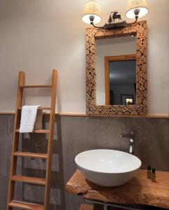 a bathroom with a sink and a mirror at Hotel Coeur Du Village in La Thuile +104 photos