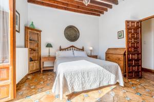 a bedroom with a bed and a wooden floor at Carmen de los Moriscos - Alhambra views in Granada