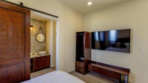 a bedroom with a large flat screen tv on the wall at Paz del Mar 16 in Las Conchas