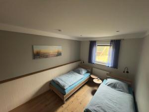 Postel nebo postele na pokoji v ubytování Ferienhaus-Maxe-Wohnung-Hannah