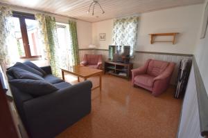 a living room with two chairs and a tv at Bo bra i Borgholm in Borgholm