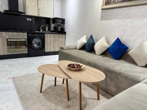a living room with a couch and a table at Studio Appartement MIRAMAR in Mohammedia