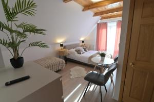 a bedroom with a bed and a table with a chair at Pino House in Zakopane