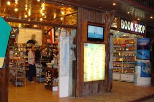 a store with a book shop with a tv in it at Neptune Hotel in Dahab