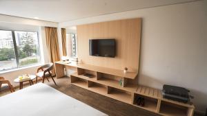 a hotel room with a television on a wall at Dazzler by Wyndham Lima Miraflores in Lima