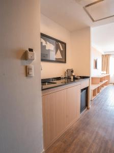 a kitchen with a sink and a counter top at Dazzler by Wyndham Lima Miraflores in Lima