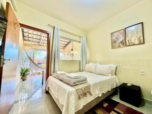 a bedroom with a bed and a large window at Pousada Casa de Maitreya in Alto Paraíso de Goiás +43 photos