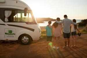 a group of people standing next to a van at Autocaravaning Menorca in Ferreries