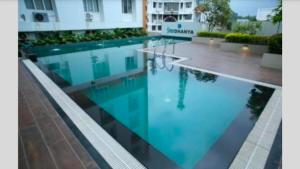 a swimming pool with blue water in a building at The Sapphire Suite in Trivandrum