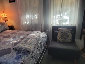 a bedroom with a bed and a chair and a window at Urban Farm House +Hot Tub+Pool in Long Beach +30 photos