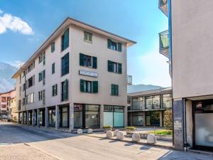a large white building with windows on a street at Apartment Jai Jai by Interhome in Colico