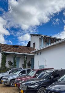 a row of cars parked in front of a building at Hotel Casa Manoa Sesquile in Sesquilé