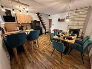 a kitchen and dining room with a table and chairs at Forest house Niko in Bosiljevo