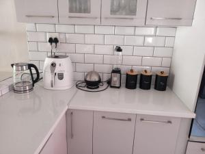 a white kitchen with a counter top with appliances at 04 at Beaumont in King Williamʼs Town