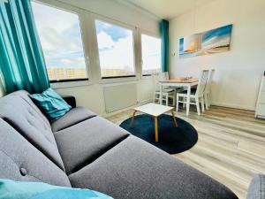a living room with a couch and a table at Ferienwohnung Südanker Fehmarn in Fehmarn