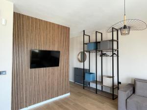 a living room with a television on a wall at Buena Vista Villas in Varna City