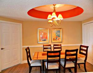 a dining room with a table with chairs and a chandelier at Wyndham Ocean Walk Resort 23321 - Vacation in Comfort and luxury - 2BR Oceanview in Daytona Beach