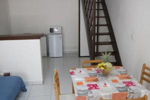 a dining room with a table and a staircase at Appartement charmant au Gosier, 60 m², terrasse in Le Gosier