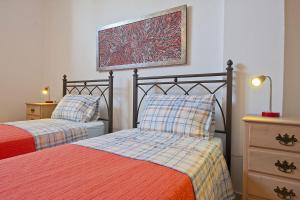 Un dormitorio con dos camas y un cuadro en la pared. en Niovi Antiparos Luxury Villas, en Soros 55 fotos más
