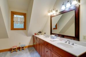 a bathroom with a sink and a large mirror at Creekside Family Retreat by Waterfalls and Hiking! in Sapphire +36 photos