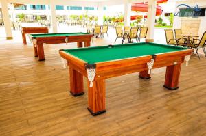 two pool tables in a room with chairs and a pool table at Lacqua diRoma - V com Roupas de cama incluso in Caldas Novas