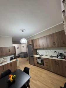 a kitchen with wooden cabinets and a table in a room at Niki's cozy apartment in Mytilene