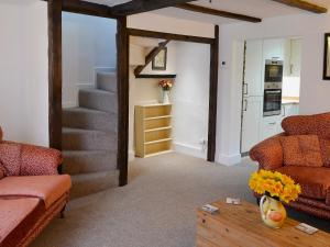 a living room with a staircase and a table at The Cottage in Broadstairs