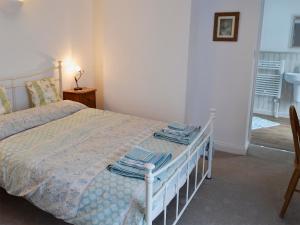 a bedroom with a bed with blue towels on it at The Cottage in Broadstairs +6 photos