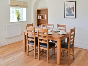 a dining room with a wooden table and chairs at Three The Boulevard in Sheringham