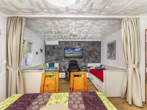 a bedroom with a bed and a desk and a couch at Holiday Home Mediana by Interhome in Balatonmáriafürdő