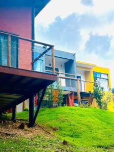 a colorful house with a balcony in front of it at Mountain House Hospedagem in Monte Verde