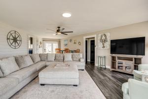 a living room with a couch and a flat screen tv at Private Beach and Fishing Pier Wicomico River House in Chance